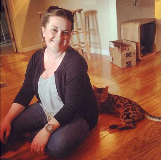 Sitting as close as possible to E without actually physically touching her.